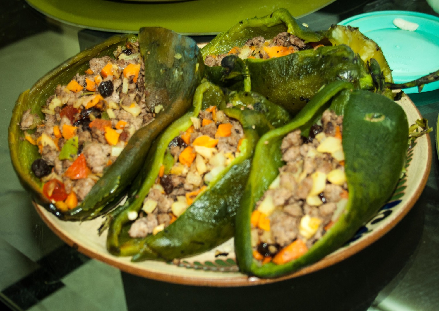 : Chiles en Nogadas, grilled chile poblanos stuffed with minced beef, carrots and raisins, potatoes then topped with a walnut cream sauce.